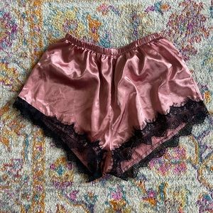 Pink satin pajama shorts worn lace